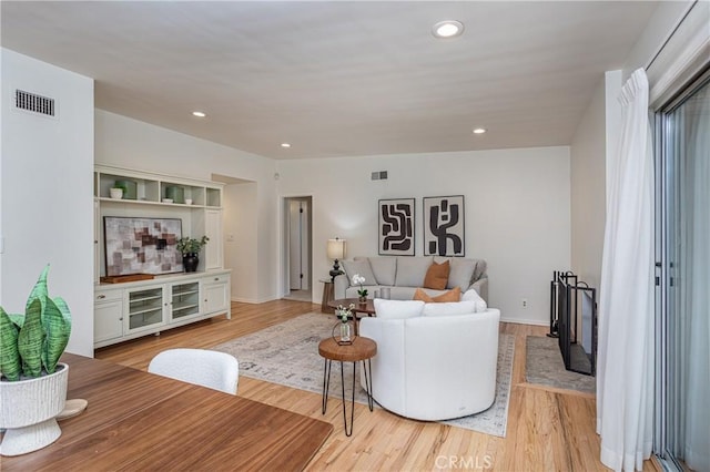 15713 Tuba St, North Hills, CA 91343 - living area featuring light wood finished floors and recessed lighting