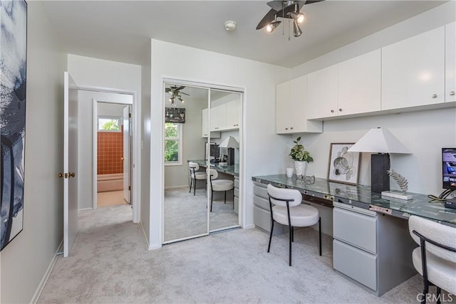 15713 Tuba St, North Hills, CA 91343 - home office featuring a ceiling fan, built in desk, and light colored carpet