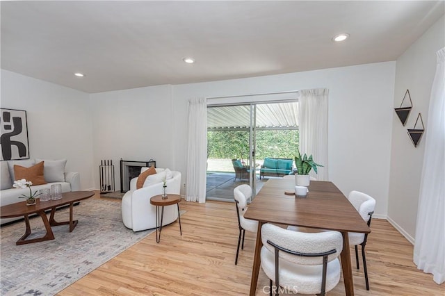 15713 Tuba St, North Hills, CA 91343 - dining room with light wood-style flooring, recessed lighting, and a fireplace