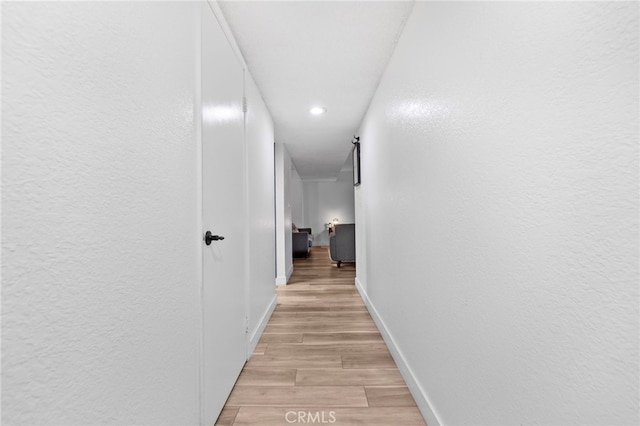 1110 Ohio Ave Unit 107, Long Beach, CA 90804 - hallway featuring light wood finished floors, recessed lighting, and a textured wall