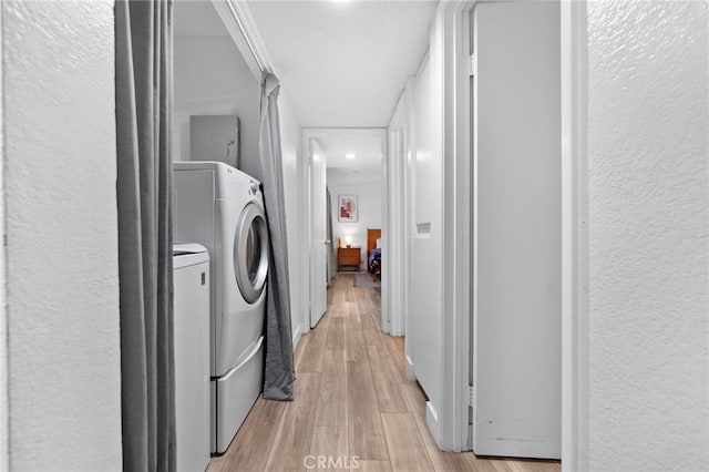 1110 Ohio Ave Unit 107, Long Beach, CA 90804 - washroom featuring a textured wall, light wood-style flooring, recessed lighting, and separate washer and dryer