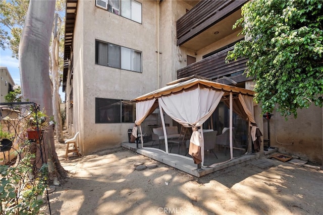 1110 Ohio Ave Unit 107, Long Beach, CA 90804 - rear view of house featuring stucco siding and a patio area