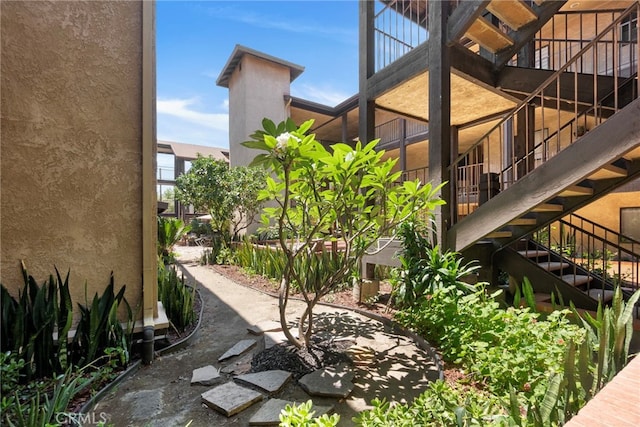 1110 Ohio Ave Unit 107, Long Beach, CA 90804 - view of home's exterior featuring stucco siding and stairway