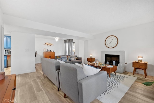 1110 Ohio Ave Unit 107, Long Beach, CA 90804 - living area featuring light wood-style flooring and a brick fireplace