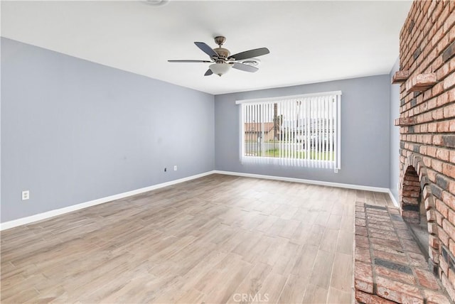 42397 Santiago Dr, Hemet, CA 92544 - unfurnished living room with ceiling fan, wood finished floors, and a fireplace