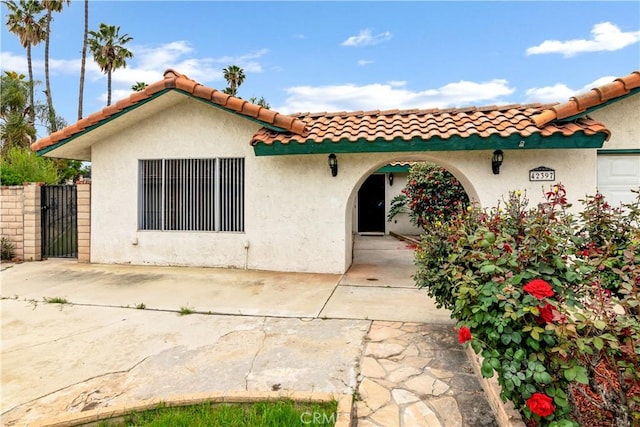 42397 Santiago Dr, Hemet, CA 92544 - rear view of property featuring a tile roof, stucco siding, and a gate