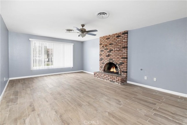 42397 Santiago Dr, Hemet, CA 92544 - unfurnished living room featuring ceiling fan, light wood finished floors, and a brick fireplace