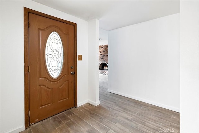 42397 Santiago Dr, Hemet, CA 92544 - foyer entrance with wood finished floors and a brick fireplace