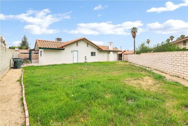42397 Santiago Dr, Hemet, CA 92544 - rear view of property featuring a fenced backyard, a tile roof, a chimney, and stucco siding