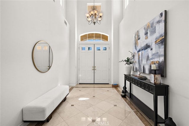 2189 Wind River Ln, Rowland Heights, CA 91748 - entryway featuring inlaid floor details, a chandelier, and a towering ceiling