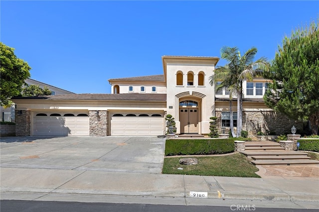 2189 Wind River Ln, Rowland Heights, CA 91748 - mediterranean / spanish-style home with a garage, concrete driveway, and stucco siding
