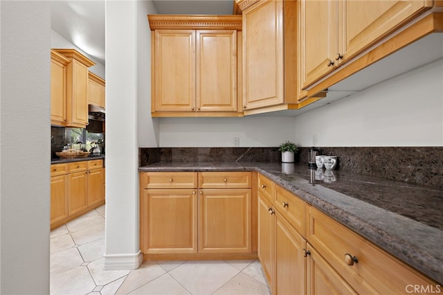 2189 Wind River Ln, Rowland Heights, CA 91748 - kitchen featuring light tile patterned floors, dark stone countertops, backsplash, and light brown cabinetry