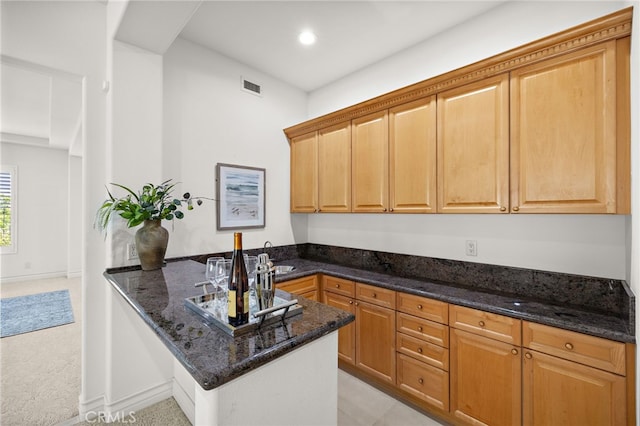 2189 Wind River Ln, Rowland Heights, CA 91748 - kitchen featuring a peninsula, dark stone counters, recessed lighting, and light carpet