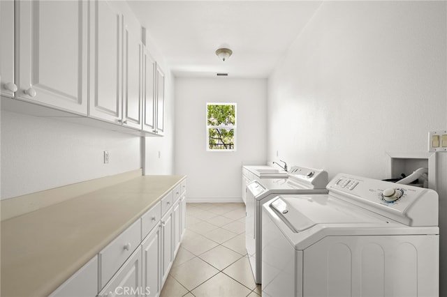 2189 Wind River Ln, Rowland Heights, CA 91748 - washroom with cabinet space, washing machine and clothes dryer, and light tile patterned floors