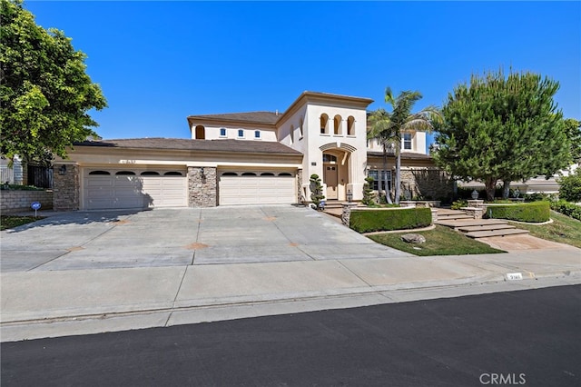 2189 Wind River Ln, Rowland Heights, CA 91748 - mediterranean / spanish home with an attached garage, concrete driveway, and stucco siding