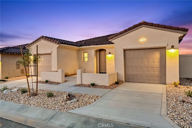 7432 Desert Sky Dr, Yucca Valley, CA 92284 - mediterranean / spanish-style home with a garage, driveway, stucco siding, and a tile roof