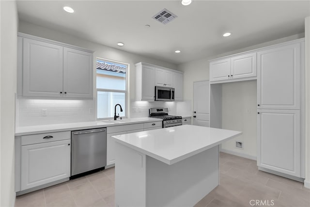 7432 Desert Sky Dr, Yucca Valley, CA 92284 - kitchen featuring appliances with stainless steel finishes, white cabinets, backsplash, and recessed lighting