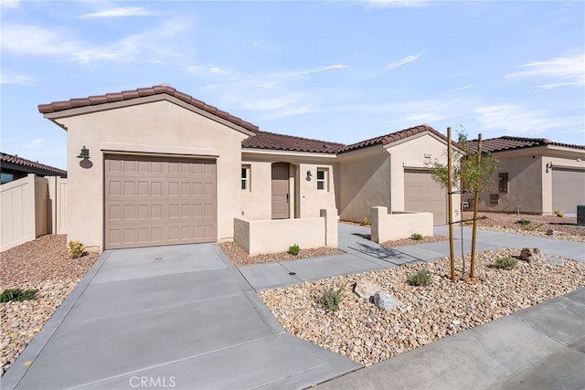 7432 Desert Sky Dr, Yucca Valley, CA 92284 - mediterranean / spanish-style home with an attached garage, concrete driveway, stucco siding, and a tiled roof