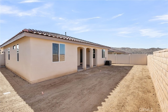 7432 Desert Sky Dr, Yucca Valley, CA 92284 - rear view of house with a fenced backyard, a tile roof, stucco siding, and a patio