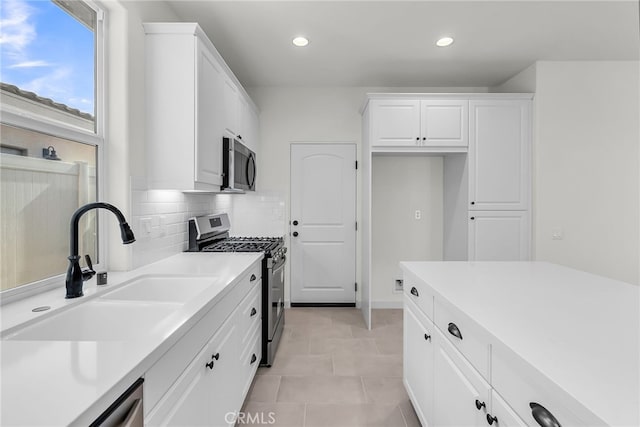 7432 Desert Sky Dr, Yucca Valley, CA 92284 - kitchen with stainless steel appliances, white cabinetry, backsplash, recessed lighting, and light countertops