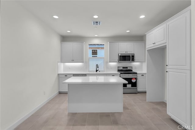 7432 Desert Sky Dr, Yucca Valley, CA 92284 - kitchen with stainless steel appliances, decorative backsplash, white cabinetry, and recessed lighting