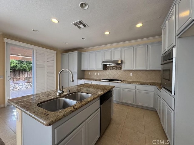 14610 Baylor Ave, Chino, CA 91710 - kitchen with stainless steel appliances, a kitchen island with sink, light tile patterned flooring, decorative backsplash, and under cabinet range hood