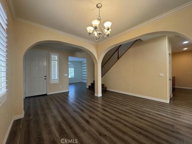 14610 Baylor Ave, Chino, CA 91710 - foyer with a chandelier, stairway, dark wood-type flooring, arched walkways, and crown molding