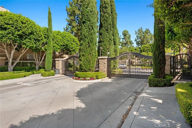 52 Anjou, Newport Coast, CA 92657 - view of concrete road with a gate, curbs, and a gated entry