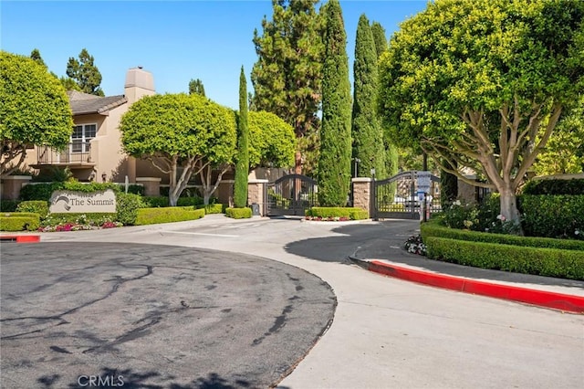 52 Anjou, Newport Coast, CA 92657 - view of home's community with a gate and uncovered parking