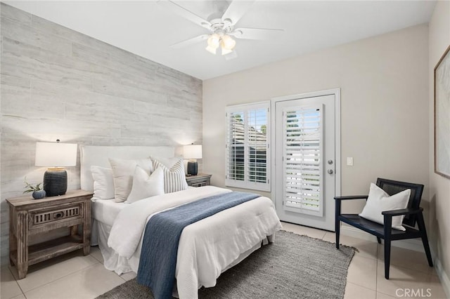 52 Anjou, Newport Coast, CA 92657 - bedroom featuring light tile patterned flooring, access to outside, an accent wall, ceiling fan, and tile walls