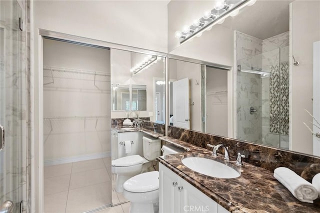 52 Anjou, Newport Coast, CA 92657 - bathroom featuring a shower stall, vanity, a walk in closet, and tile patterned flooring