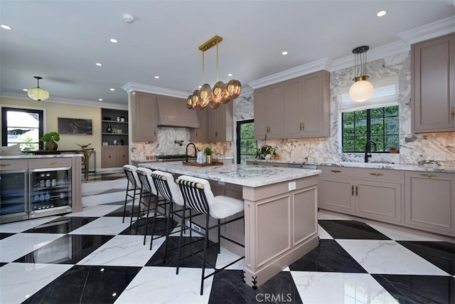 5005 Los Feliz Blvd, Los Angeles, CA 90027 - kitchen with beverage cooler, tasteful backsplash, crown molding, recessed lighting, and light stone countertops
