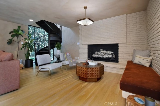 5005 Los Feliz Blvd, Los Angeles, CA 90027 - living room with wood finished floors, a brick fireplace, stairs, and brick wall