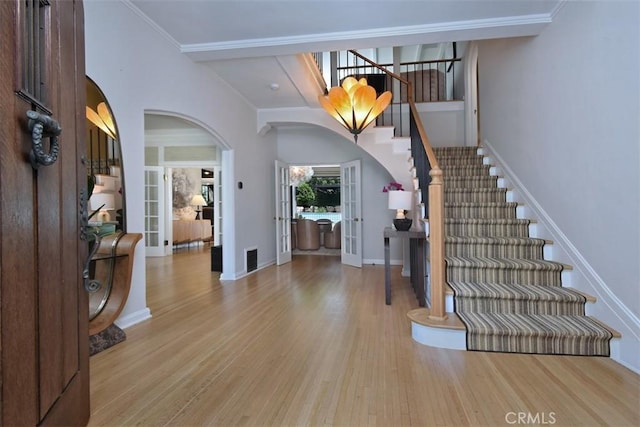 5005 Los Feliz Blvd, Los Angeles, CA 90027 - entrance foyer with arched walkways, stairway, wood finished floors, french doors, and ornamental molding