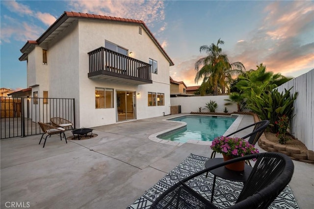 754 Manecita Cir, Perris, CA 92571 - rear view of property featuring a balcony, a fenced backyard, a fire pit, and a patio area