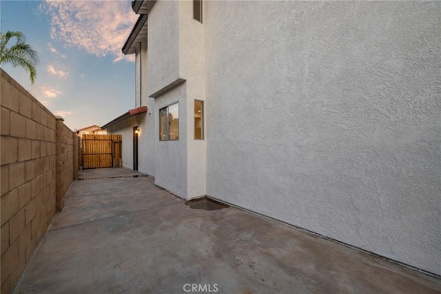 754 Manecita Cir, Perris, CA 92571 - property exterior at dusk featuring stucco siding and a patio area