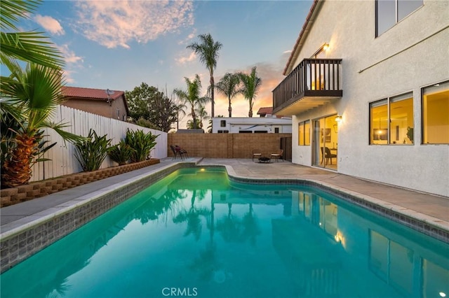 754 Manecita Cir, Perris, CA 92571 - pool at dusk with a patio area and a fenced backyard