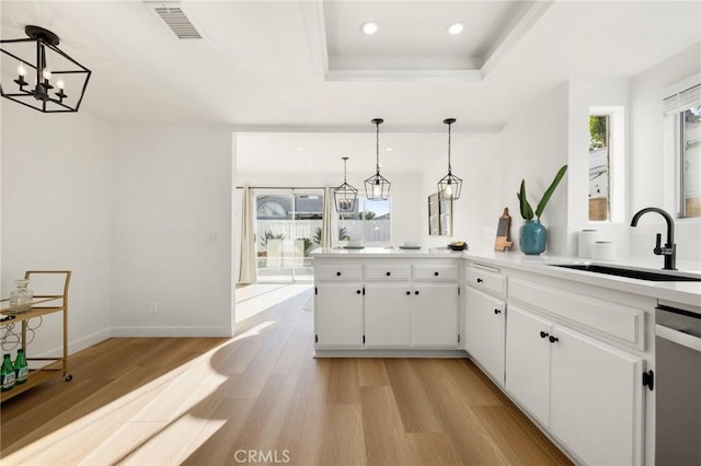 754 Manecita Cir, Perris, CA 92571 - kitchen featuring dishwasher, light wood-style flooring, a raised ceiling, white cabinetry, and recessed lighting