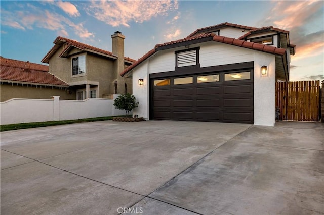 754 Manecita Cir, Perris, CA 92571 - mediterranean / spanish-style home featuring a tiled roof, driveway, a chimney, stucco siding, and an attached garage