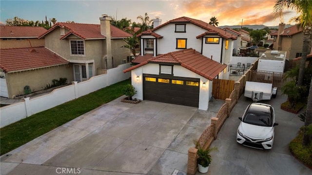 754 Manecita Cir, Perris, CA 92571 - view of front of property featuring a tile roof, driveway, stucco siding, and a chimney