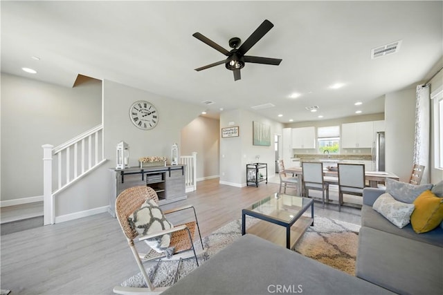 2651 W Lincoln Ave Unit 41, Anaheim, CA 92801 - living room featuring light wood-type flooring, a ceiling fan, stairs, recessed lighting, and arched walkways