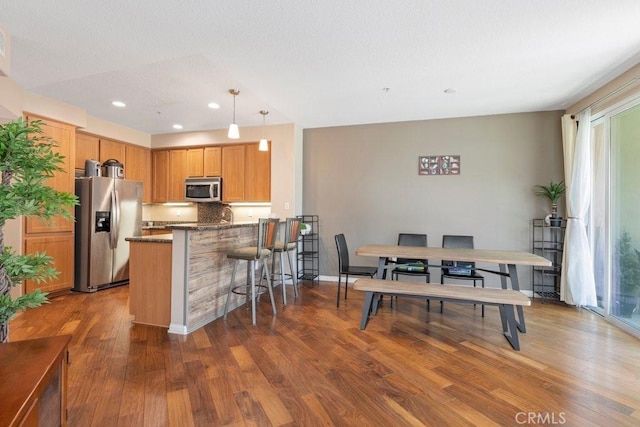 12688 Chapman Ave Unit 3403, Garden Grove, CA 92840 - kitchen with appliances with stainless steel finishes, plenty of natural light, wood finished floors, a peninsula, and recessed lighting