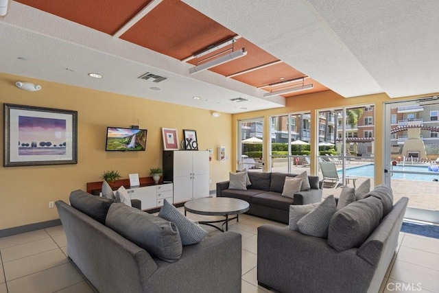 12688 Chapman Ave Unit 3403, Garden Grove, CA 92840 - living room featuring light tile patterned floors and a textured ceiling