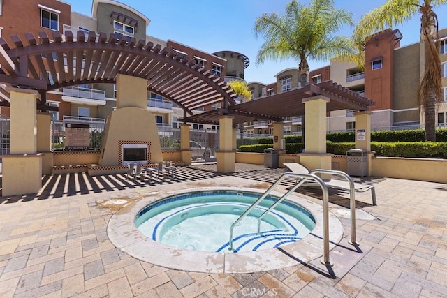 12688 Chapman Ave Unit 3403, Garden Grove, CA 92840 - view of pool featuring a fireplace, a pergola, a hot tub, and a patio area