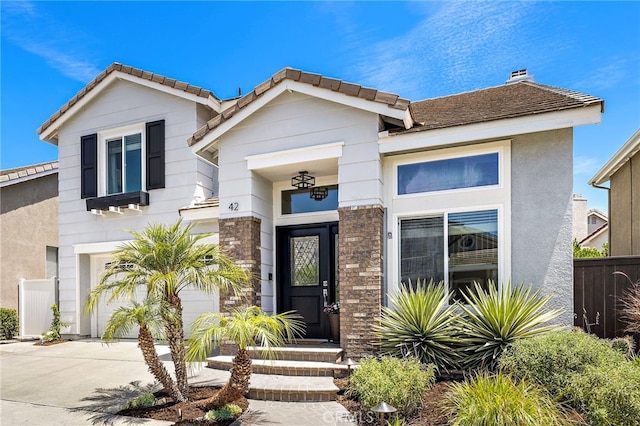 42 Beech Dr, Aliso Viejo, CA 92656 - view of front of property featuring concrete driveway, a garage, stucco siding, and a chimney