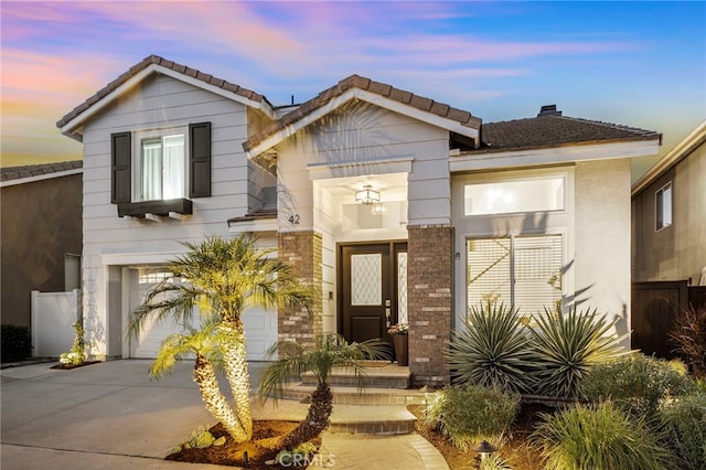 42 Beech Dr, Aliso Viejo, CA 92656 - view of front of house with concrete driveway, an attached garage, a tiled roof, and a chimney