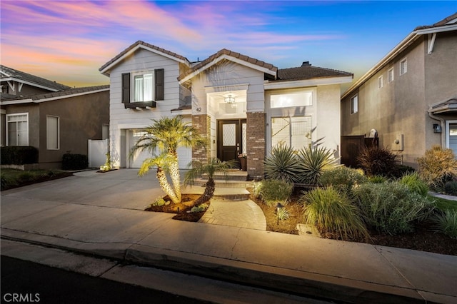 42 Beech Dr, Aliso Viejo, CA 92656 - view of front facade featuring concrete driveway, a garage, a tiled roof, and a chimney