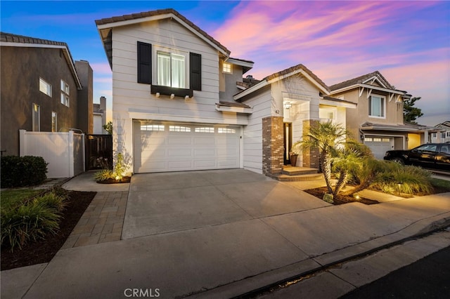 42 Beech Dr, Aliso Viejo, CA 92656 - view of front of house featuring a tiled roof, concrete driveway, and an attached garage