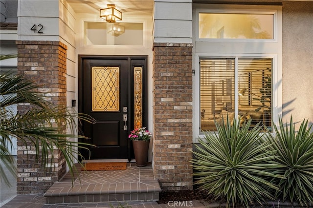 42 Beech Dr, Aliso Viejo, CA 92656 - view of exterior entry with stucco siding, brick siding, and a porch