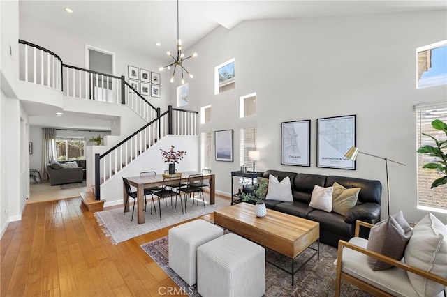 42 Beech Dr, Aliso Viejo, CA 92656 - living area with high vaulted ceiling, stairs, a chandelier, light wood-type flooring, and recessed lighting